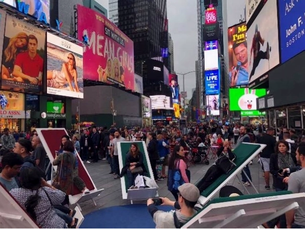 Du khách nghỉ chân và ngắm các tòa nhà cao tầng theo cách của Times Square